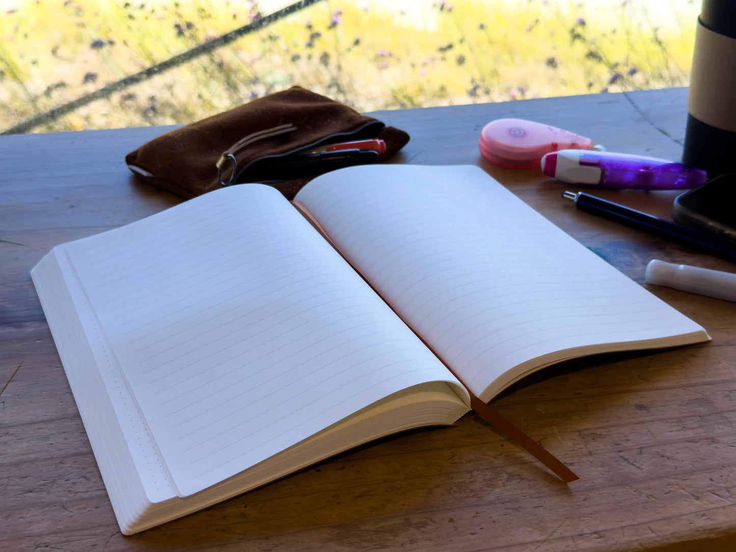 A5 notebook open on wood table