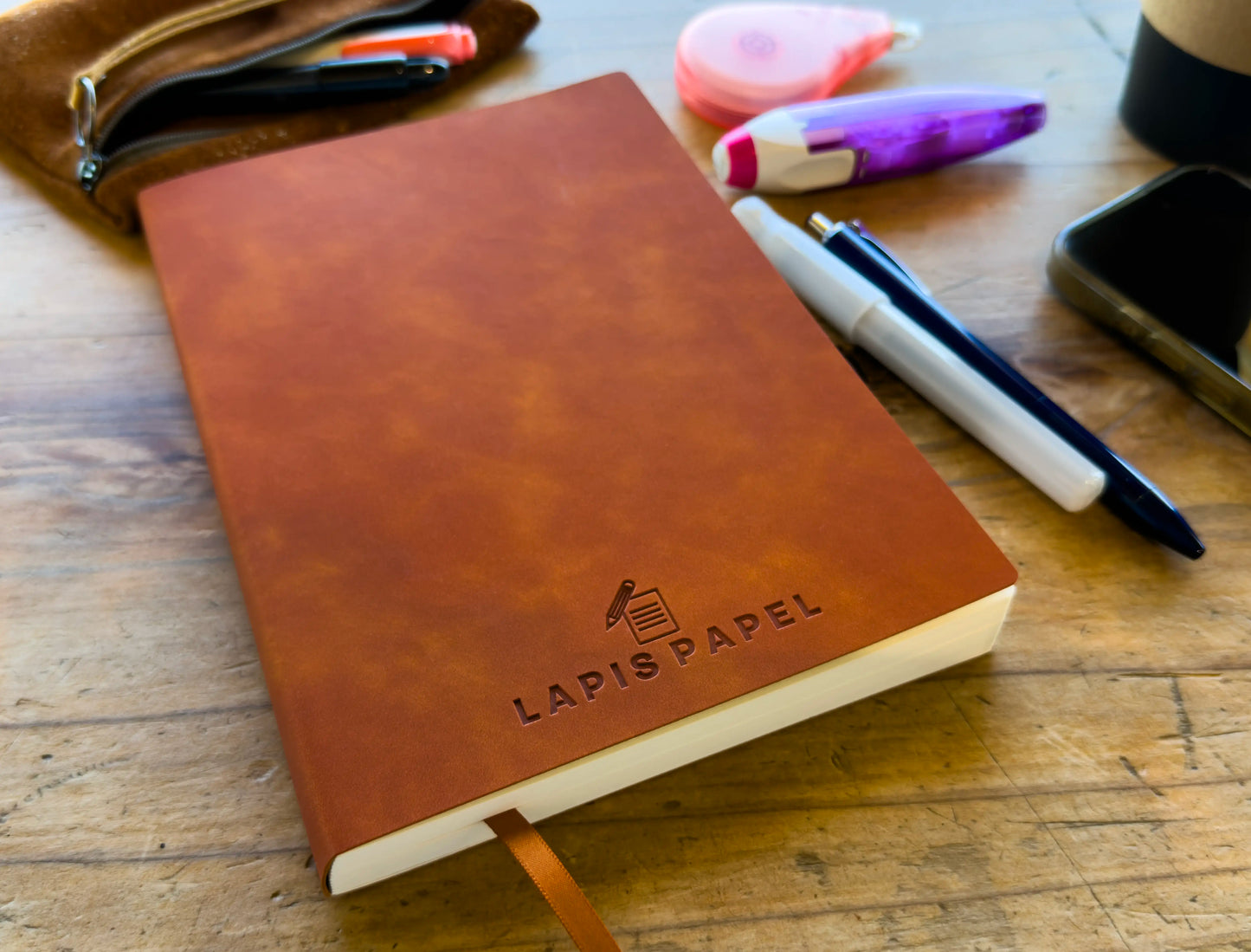 A5 notebook tan on wood table