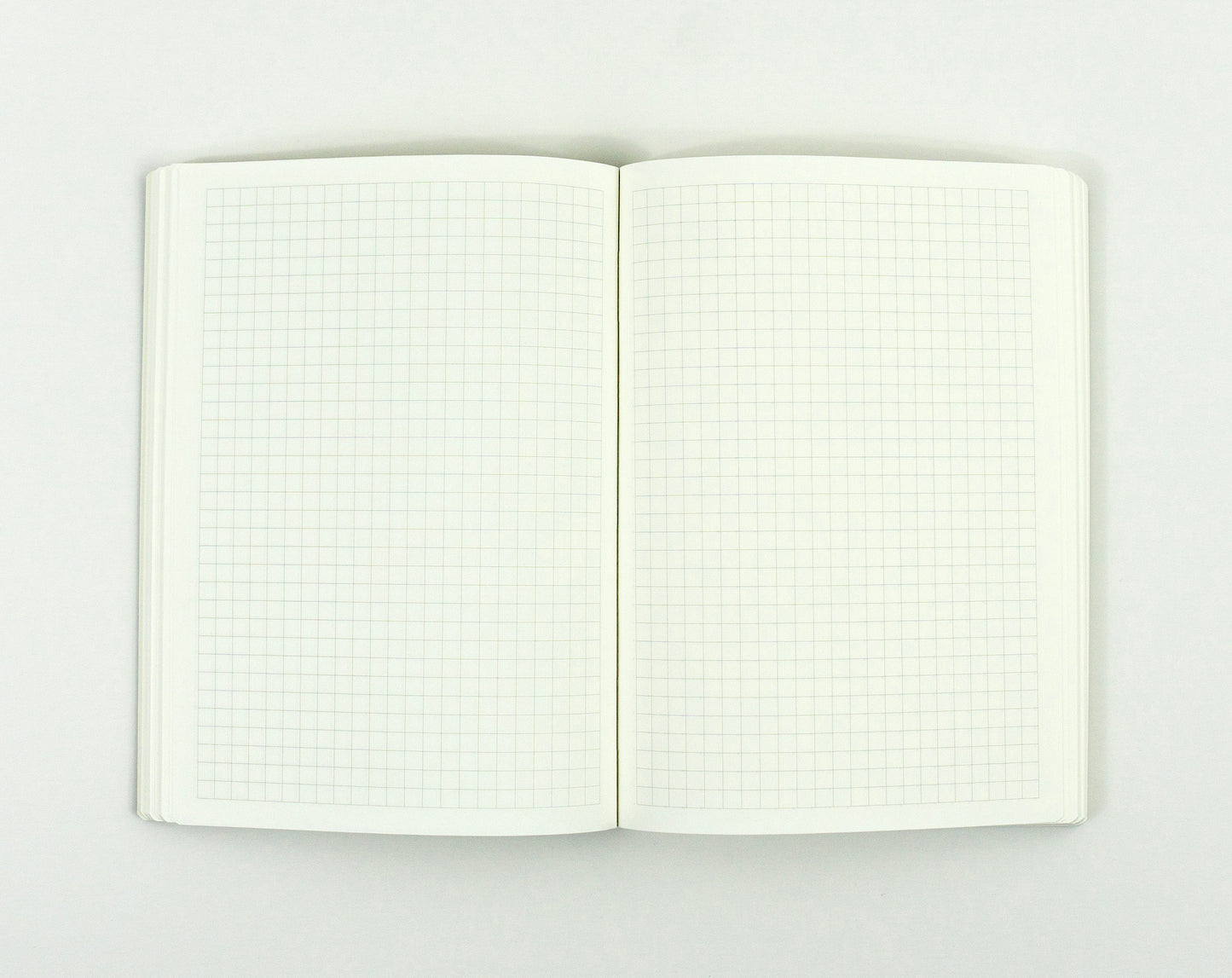 Open notebook with grid pages on a white background