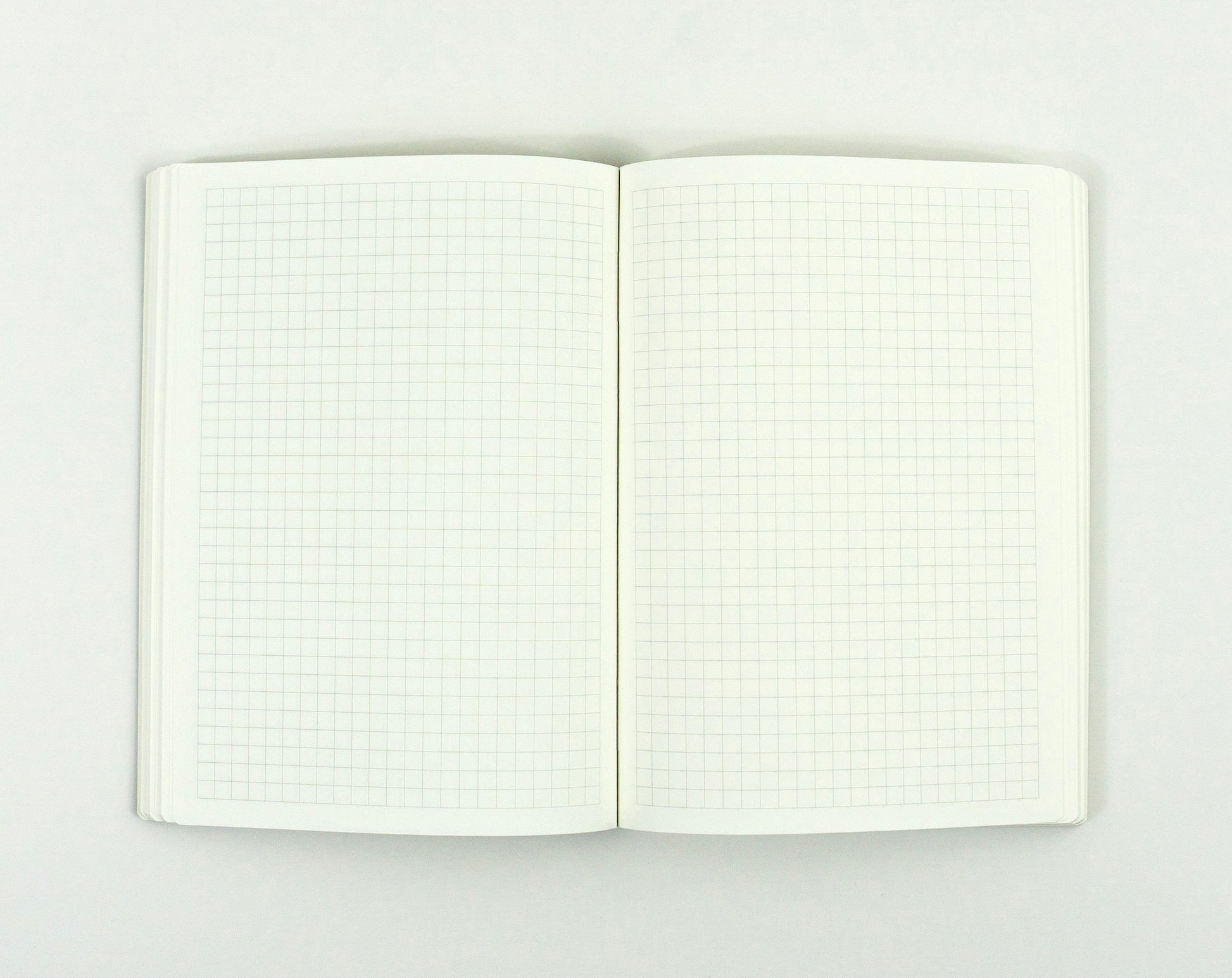 Open notebook with grid pages on a white background