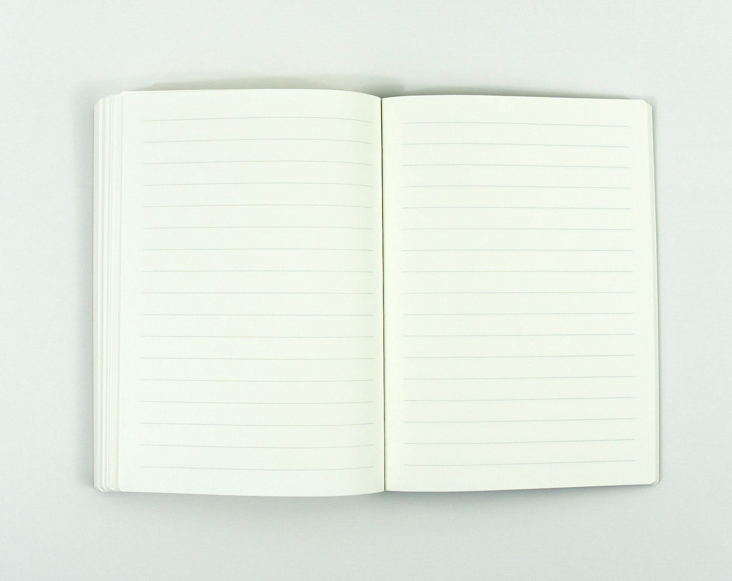 Open notebook with blank lined pages on white background