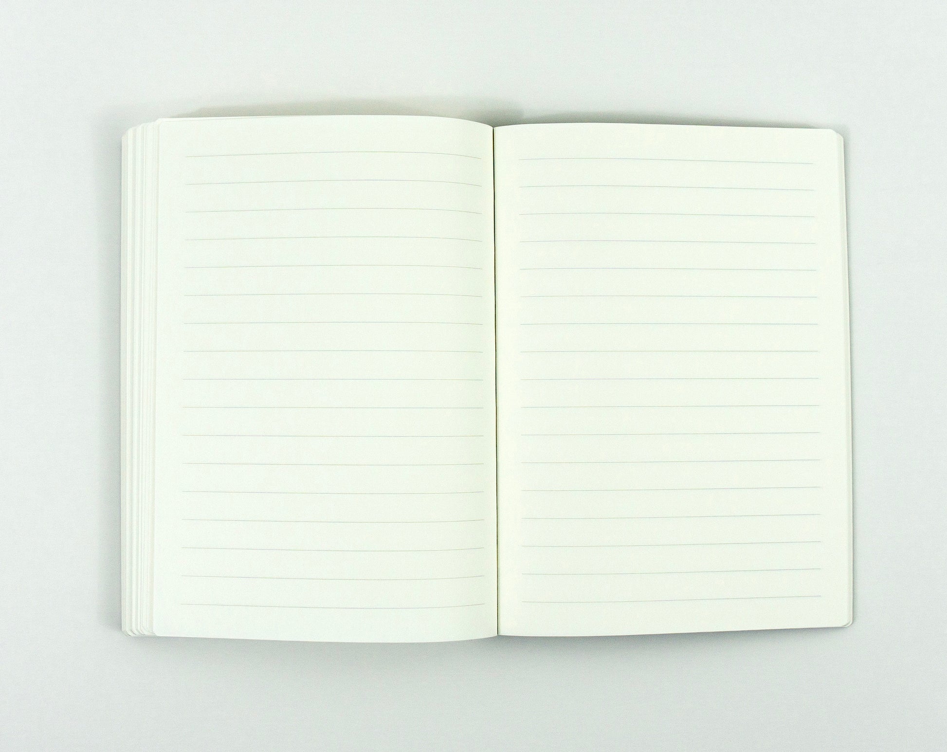 Open notebook with blank lined pages on white background